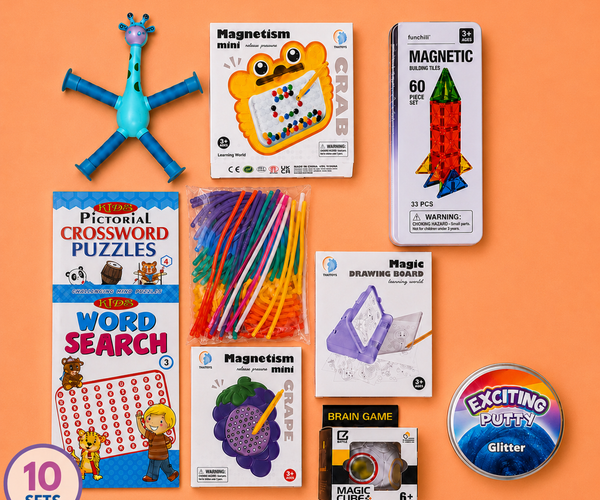 Travel On-The-Go Kit featuring 10 educational and fun sets arranged on a solid orange background. The sets include a blue giraffe toy, 'Magnetism mini' and 'Magnetic' boxes, a 'Pictorial Crossword Puzzles' book, 'Word Search' puzzle book, colorful pipe cleaners, a 'Magic Drawing Board' box, a 'Brain Game' box, a 'Magic Cubes' box, and a round 'Exciting Puffy Glitter' tin.